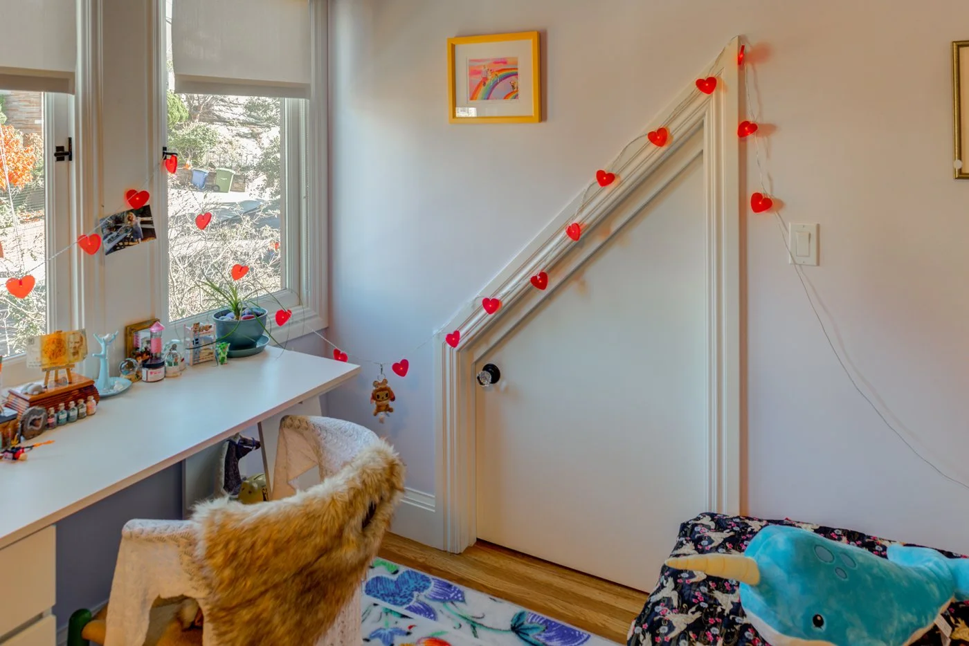 Custom closet and storage area added during the remodel, featuring a built in desk nook by the window and a new door, created by straightening the kitchen wall layout.