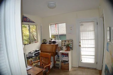 Original home office before renovation, with small windows and compact layout, prior to relocation in the Lighthearted Kitchen and Family Room Addition.