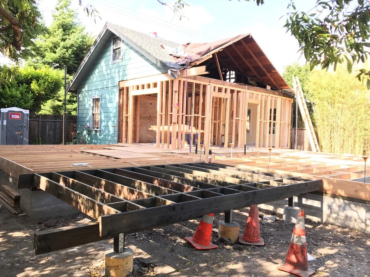 Structural floor framing underway for the Lighthearted Kitchen and Family Room Addition, showing new joists elevated on piers that prepare the foundation for expanded living space.
