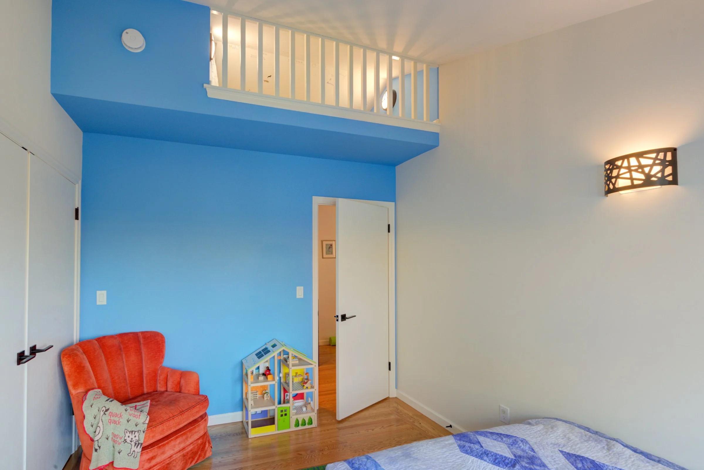 New children's Bedroom with blue accent wall and loft.