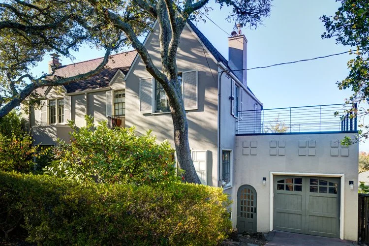 View of exterior, including the garage with the roof deck above it.