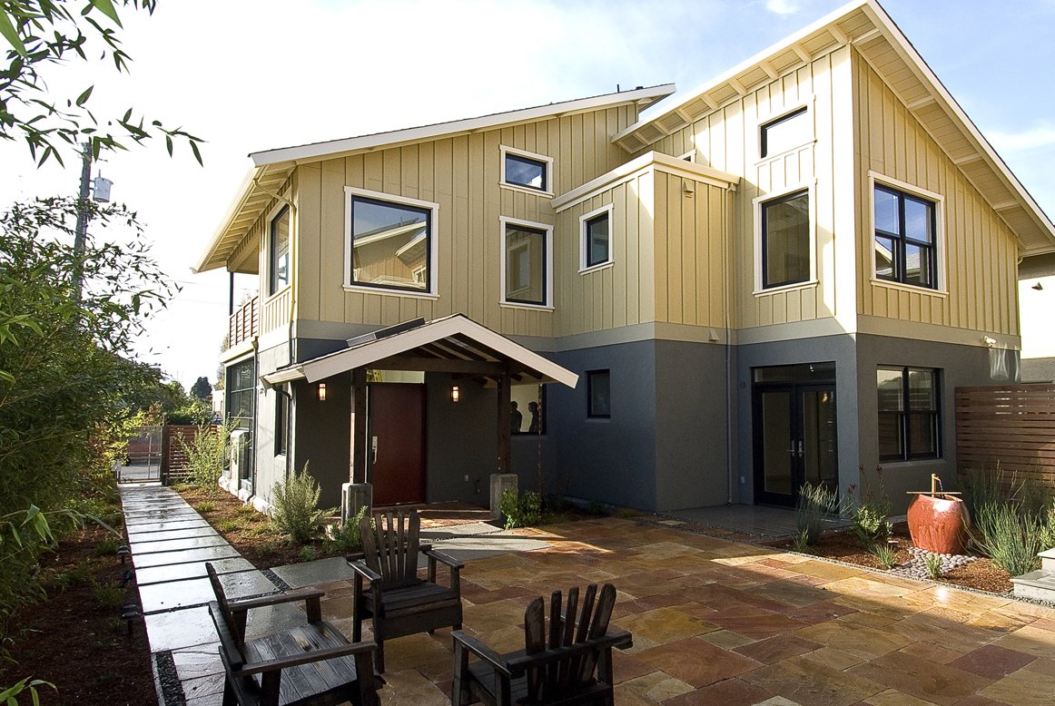 Ground level patio entry with concrete steps and brick paving, connecting indoor living areas to a private outdoor space designed for durability, accessibility, and easy outdoor use.
