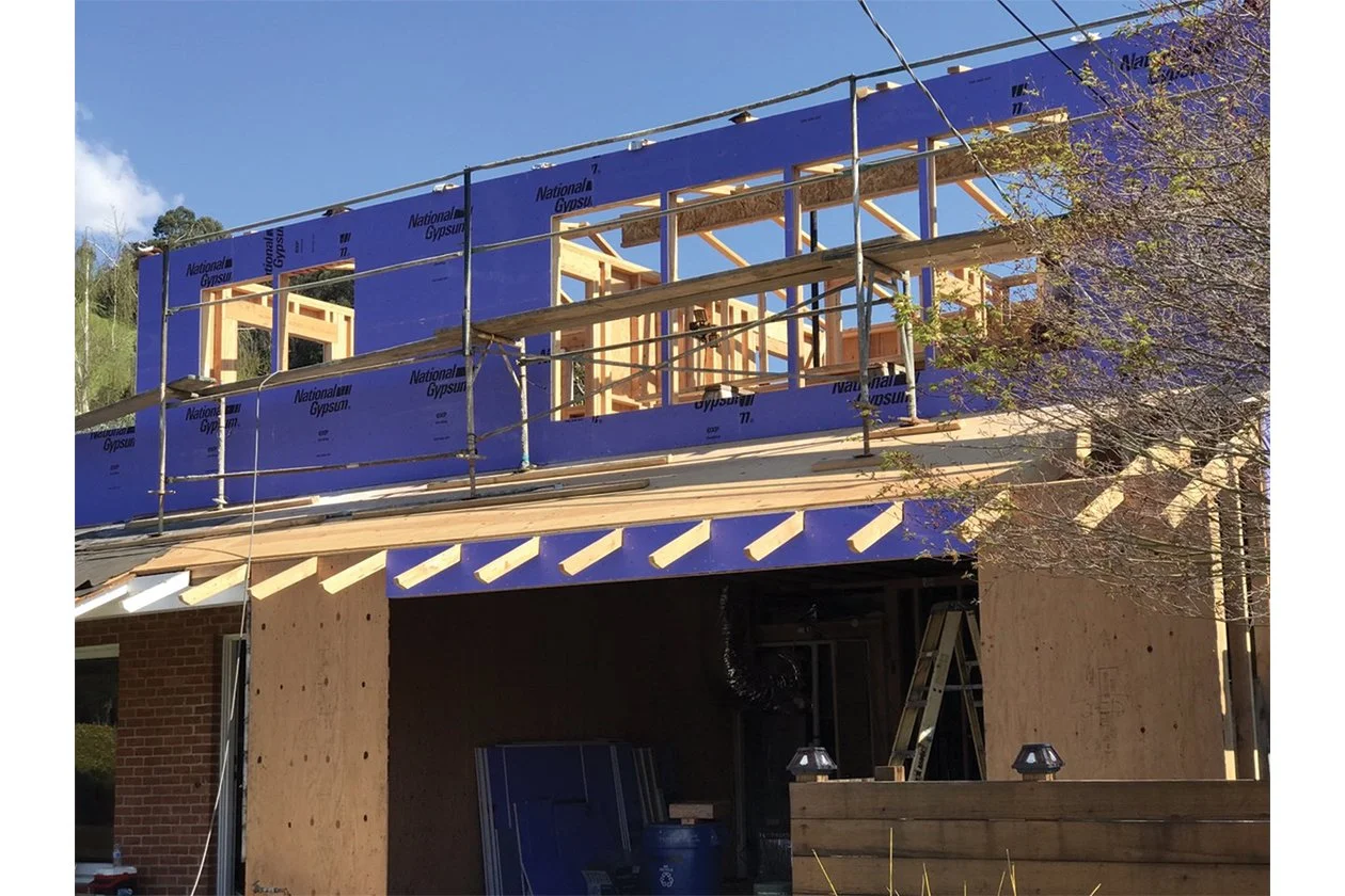 Second-story framing with weather-resistive wrap and scaffold