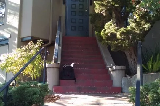 Before photo of the original steep front stairs leading to the entry door, with narrow concrete edges and limited landing space before the North Berkeley entry remodel.