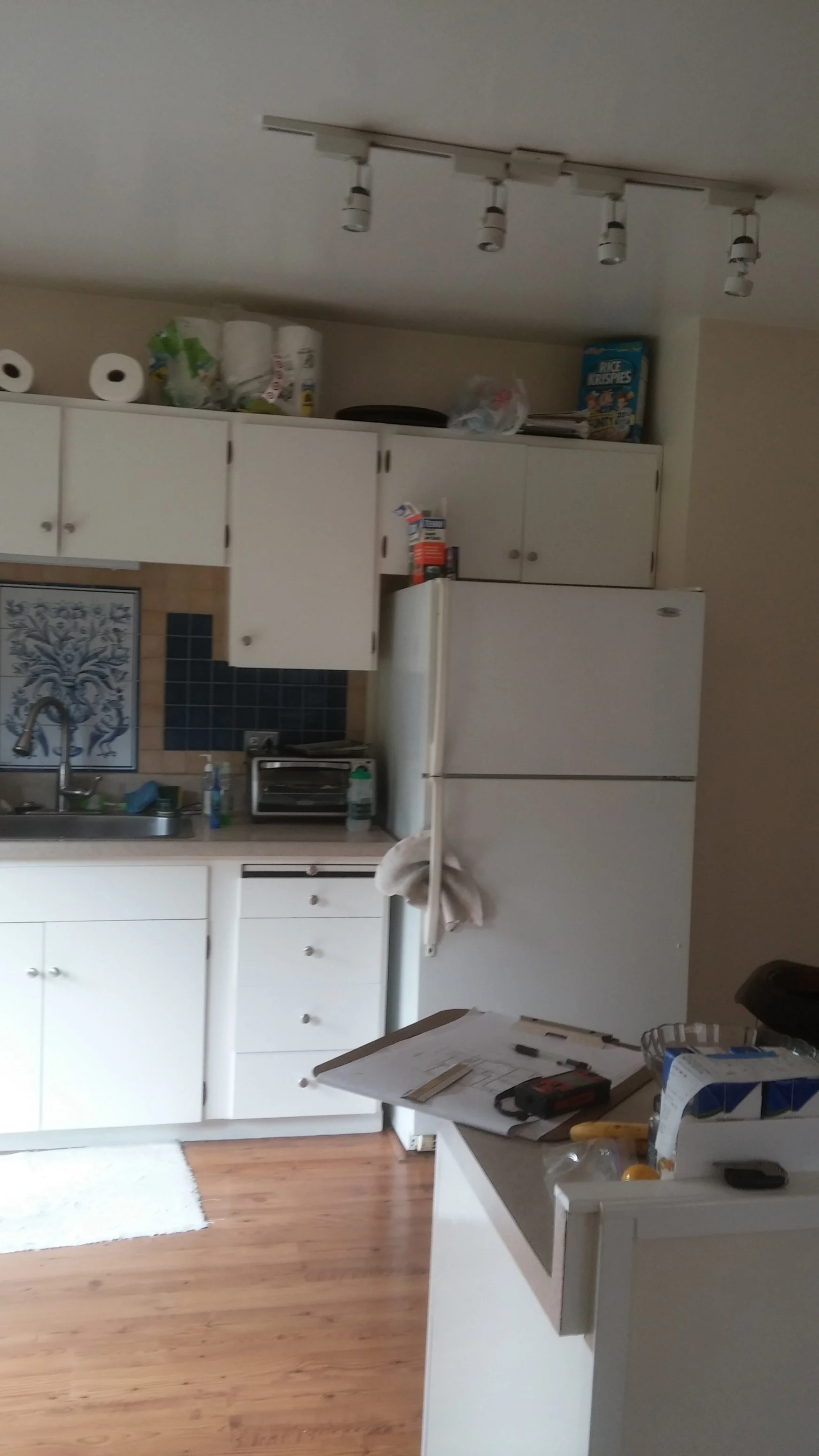 Original kitchen before remodel, with dated cabinetry and tight layout prior to the 11-square-foot addition and reconfiguration.