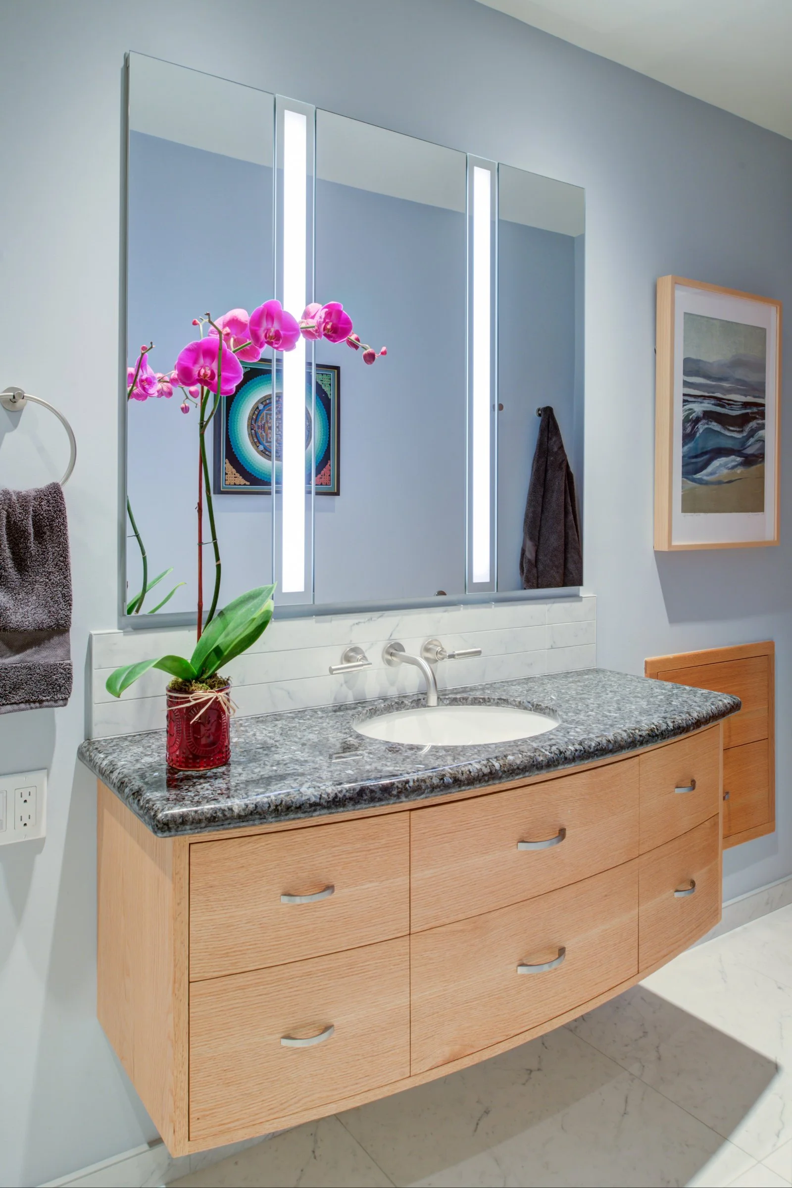 Floating cabinets with bright vanity lighting