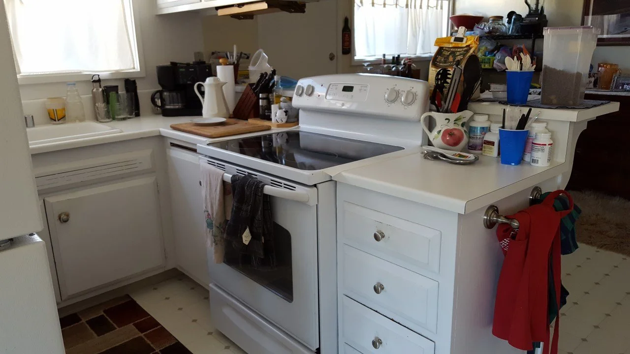 Original kitchen showing older appliances, tight work areas, and cluttered counters, highlighting functional challenges addressed in the Alameda renovation.
