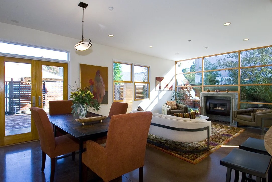 Dining area adjacent to the living room with patio doors that open to outdoor space, encouraging natural light, airflow, and seamless indoor outdoor connection.