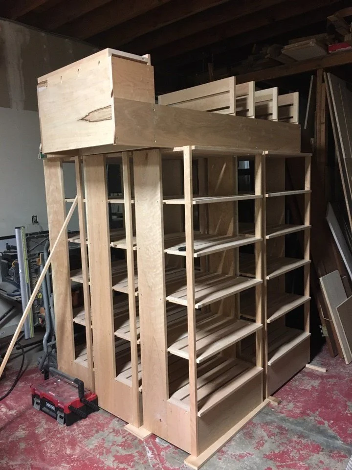 Custom built wooden pastry display cases on casters inside Arizmendi Bakery, designed to showcase baked goods while allowing flexibility within the production and retail space.