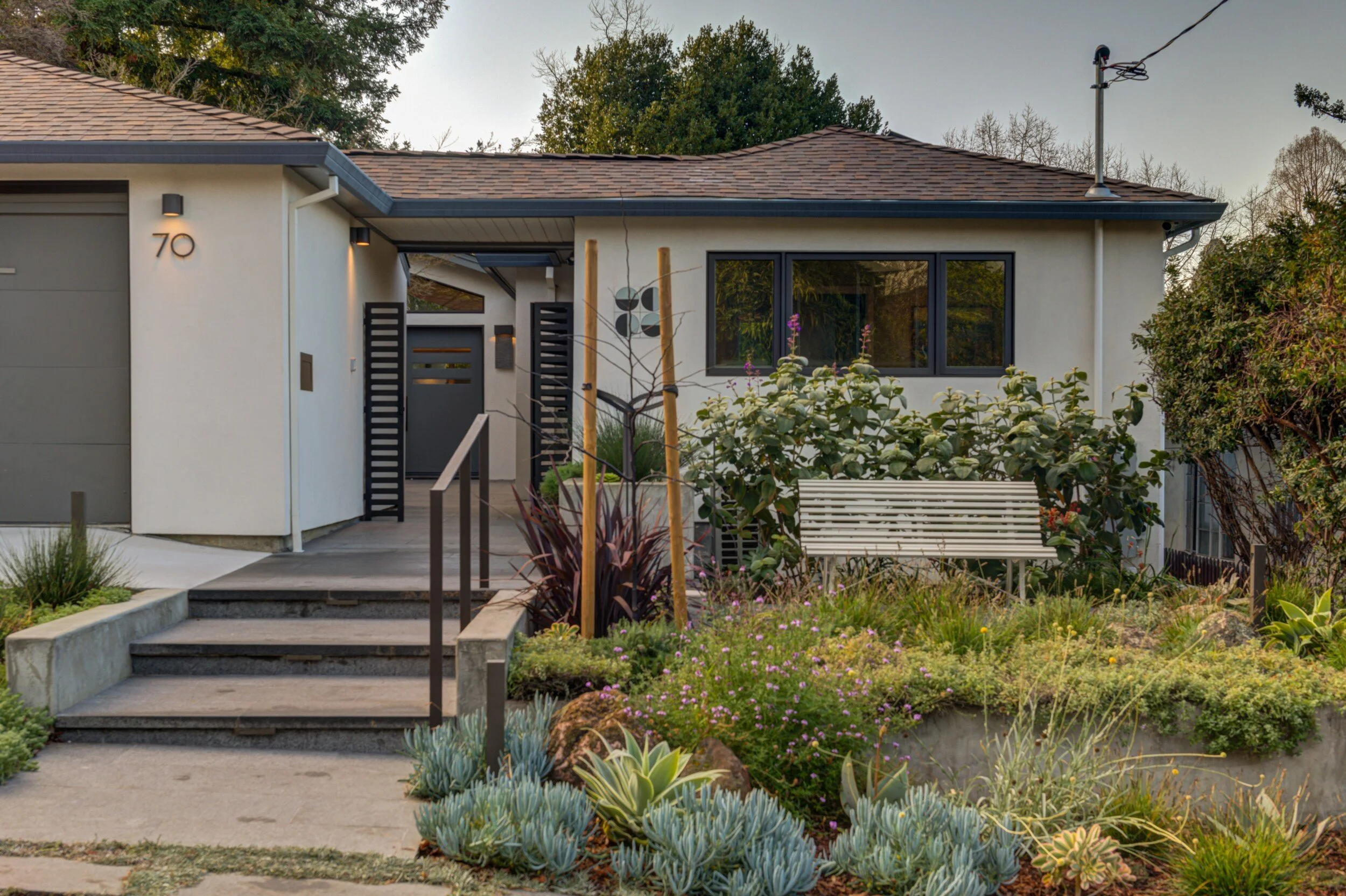 Approach to the home up shallow steps toward new courtyard gate