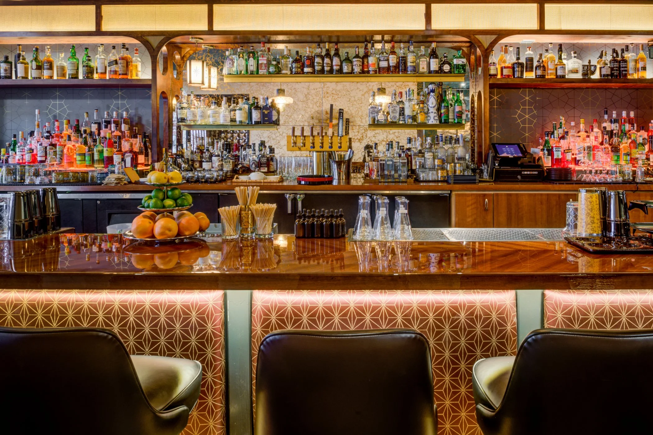 Levitch-built custom mirrored back bar with walnut bar top and brass foot rail at Bardo Lounge.