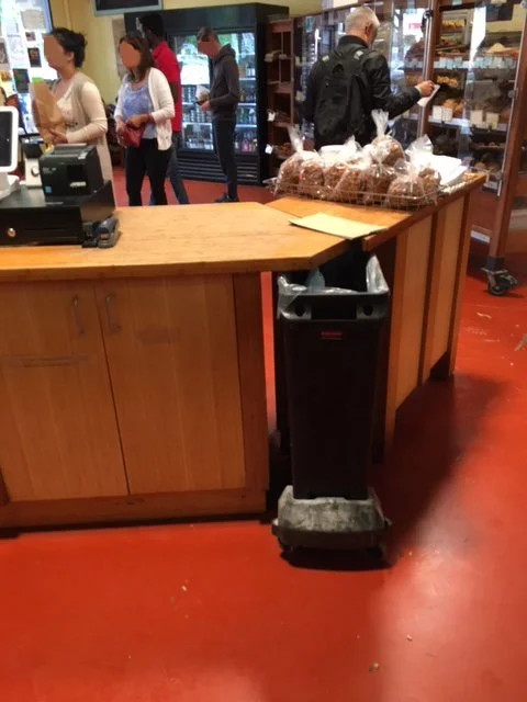 Customer service area before renovation, showing dated counters and circulation patterns, providing context for how the remodel improved flow, visibility, and accessibility.