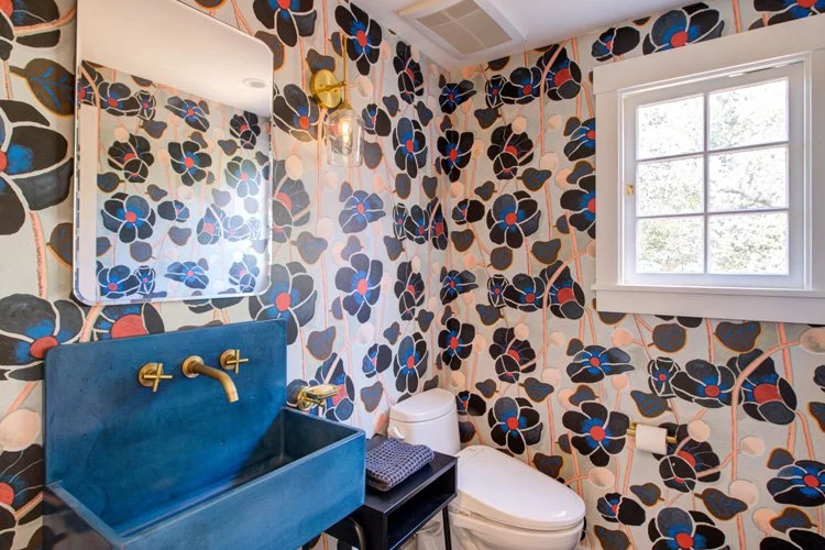 Powder room with wallpaper and periodish accents.