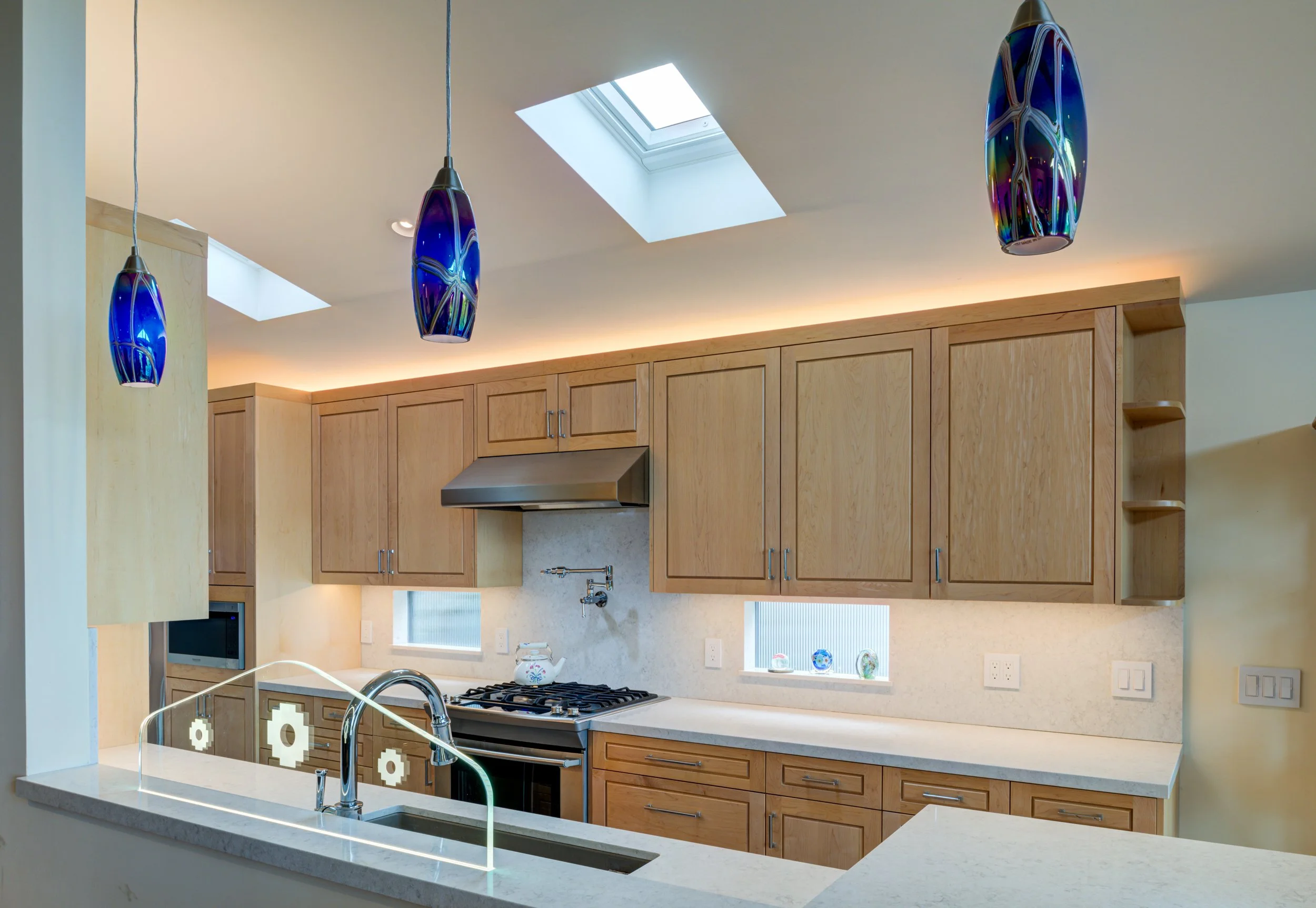 New Kitchen with pendant lights over sink, skylights and backsplash windows