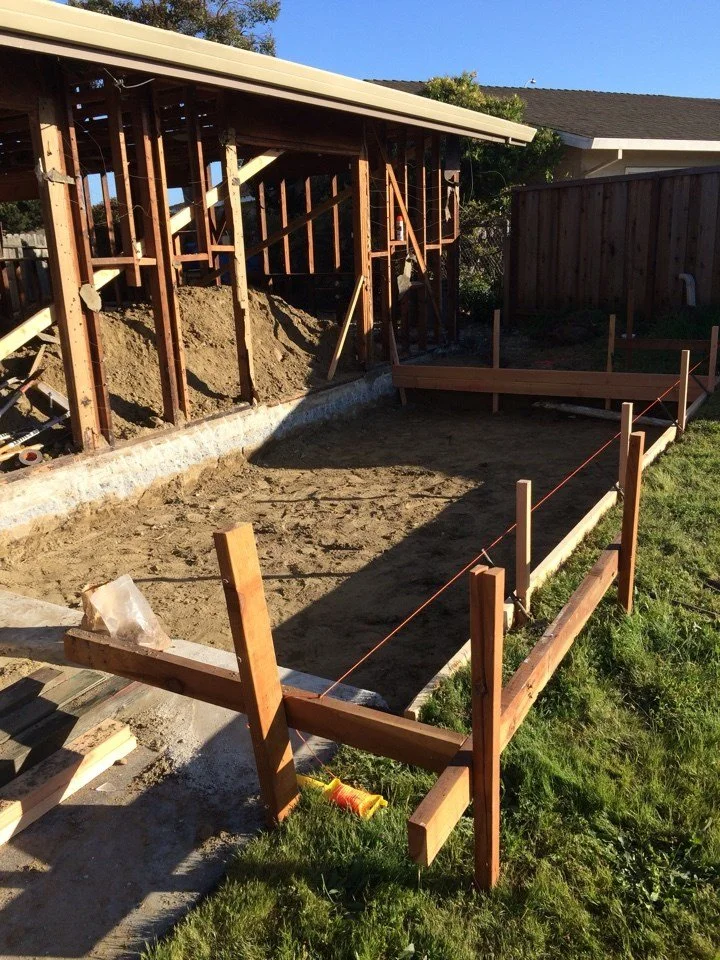 Framing and formwork for the Alameda addition showing the expanded footprint near the water side of the home prior to pouring the new foundation slab.