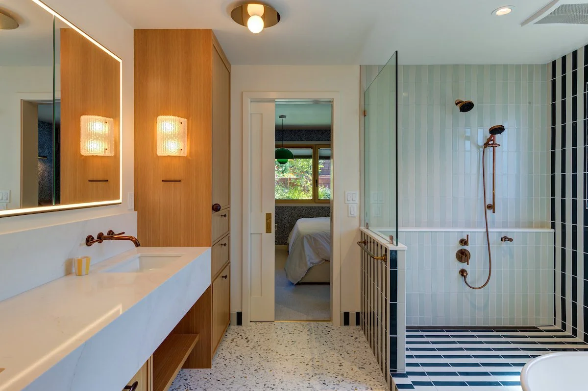Primary Bath showing connection to a Bedroom and striped tile design at the "wet room" with a shower and freestanding tub.