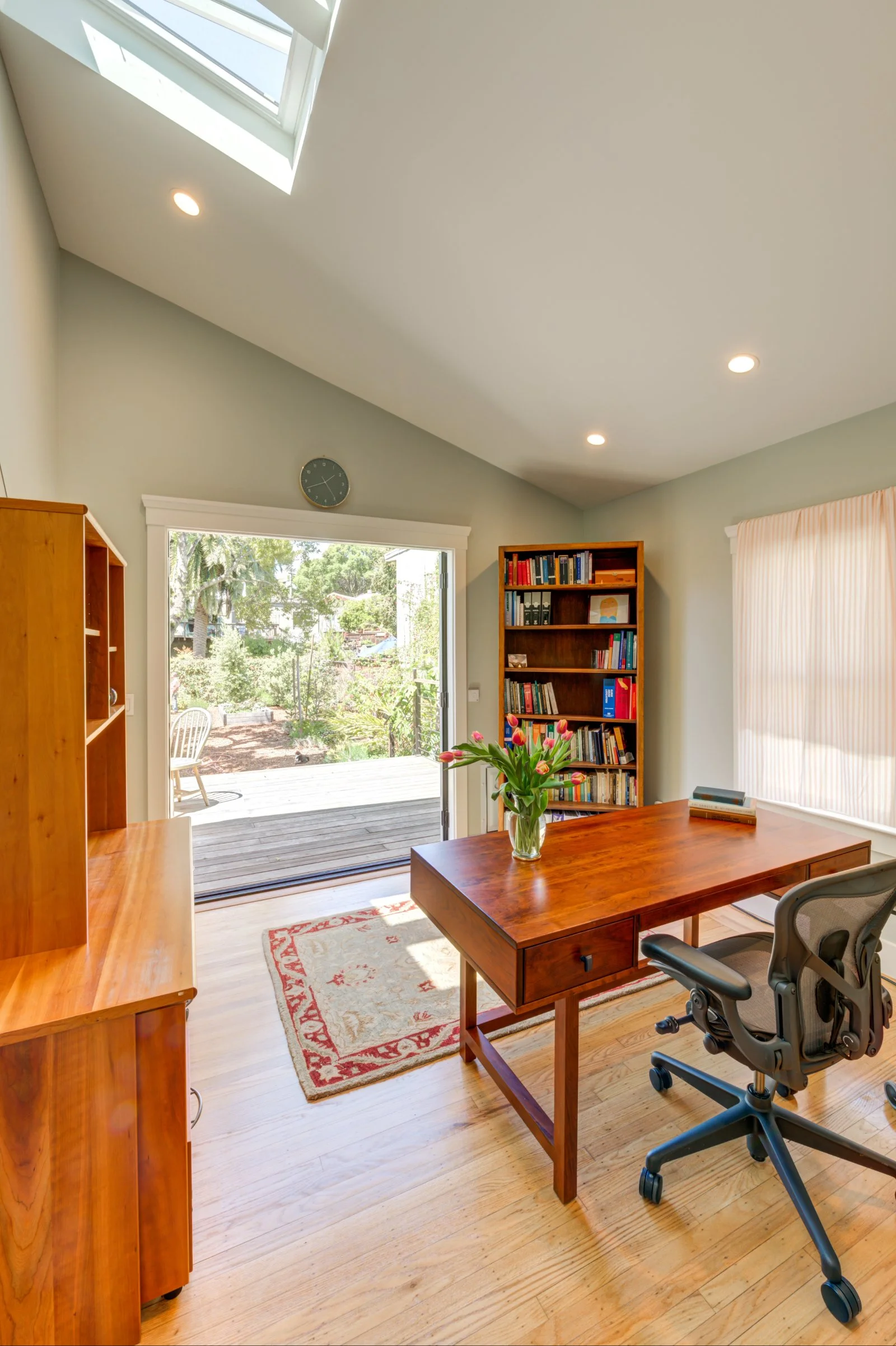 Office space with new skylight and French doors leading to the new deck for lots of natural light
