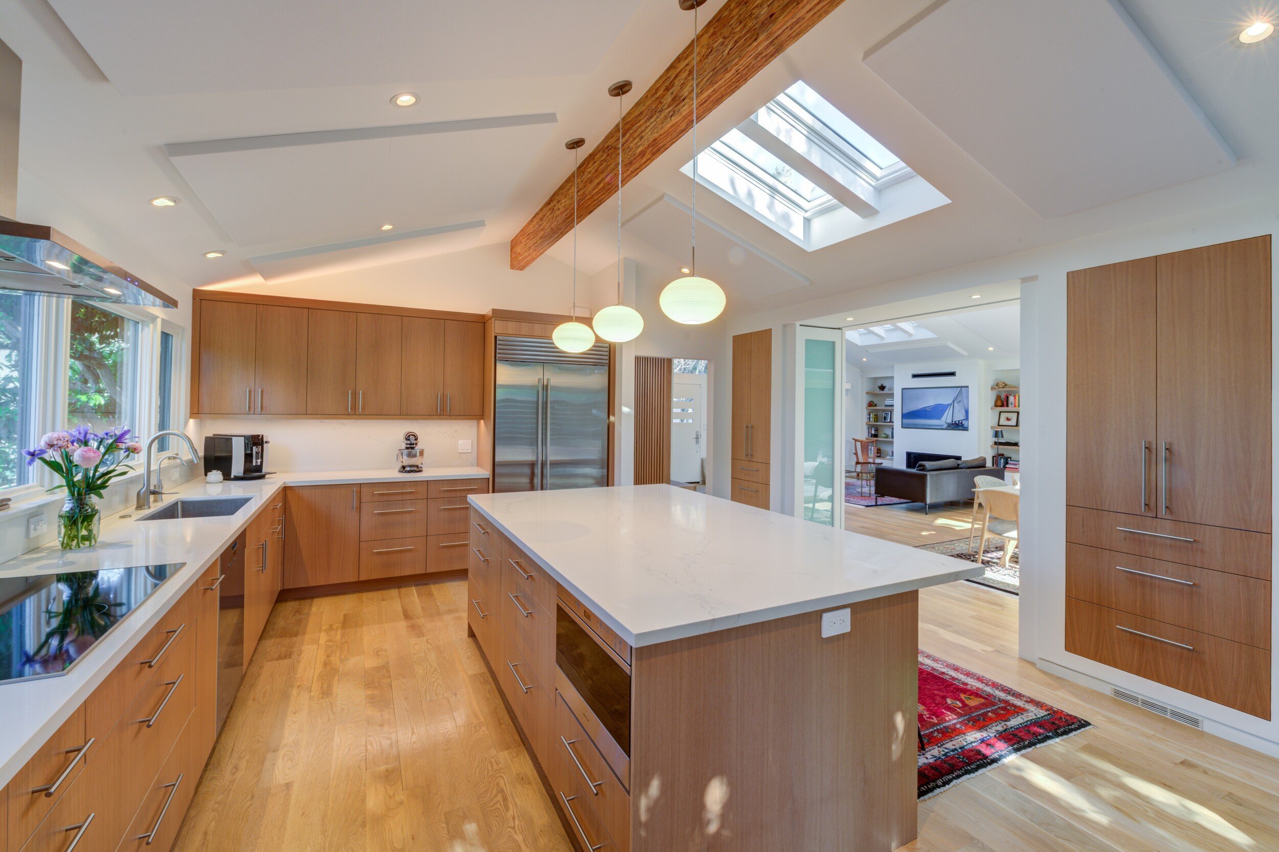 New Kitchen looking toward the front of the house. The Living Room is visible beyond and to the right through folding doors.