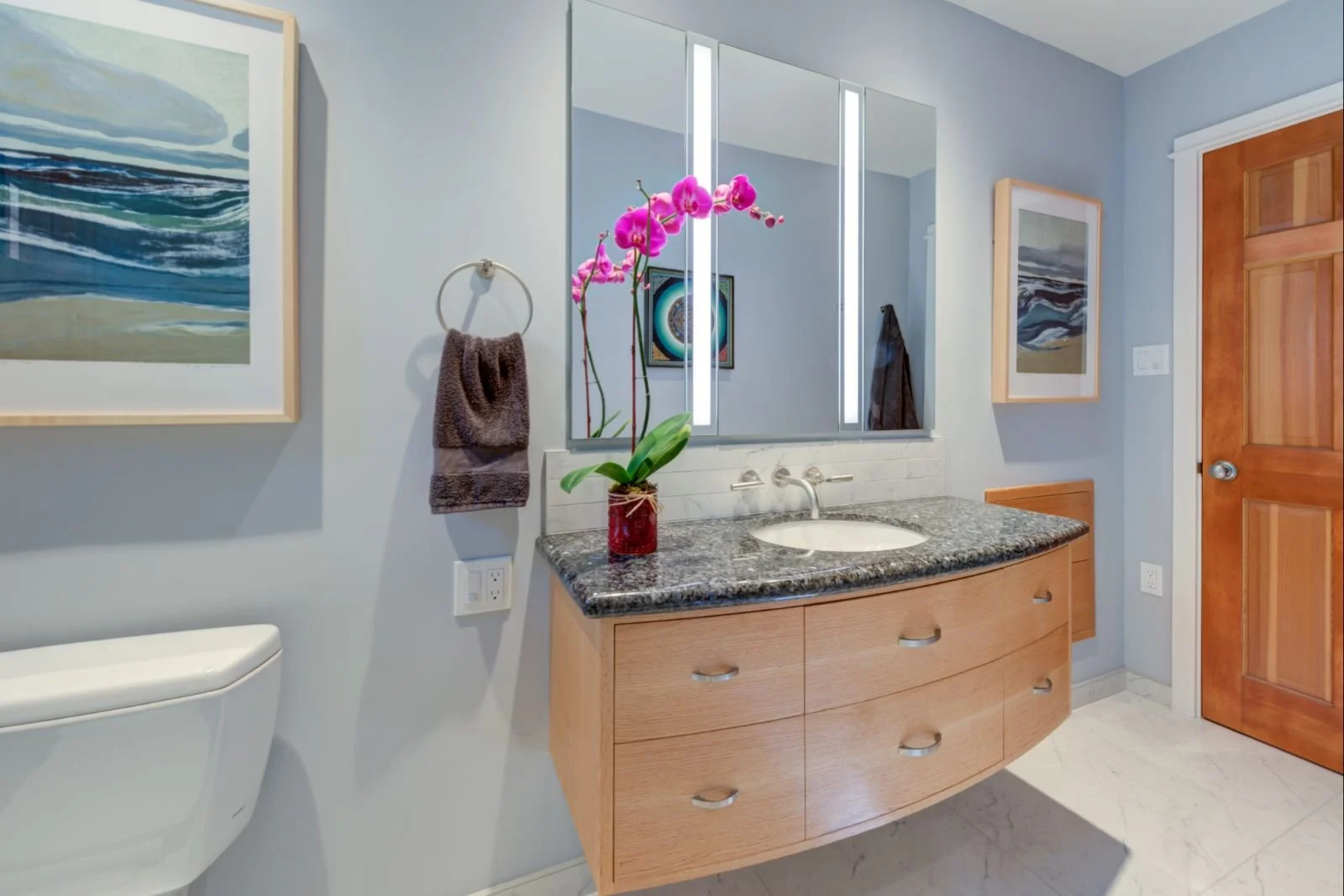 Vanity in context with the entry door and toilet