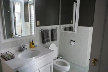 Guest Bathroom before remodel showing outdated single-sink vanity, narrow shower, and older finishes prior to expanding the space for improved function.