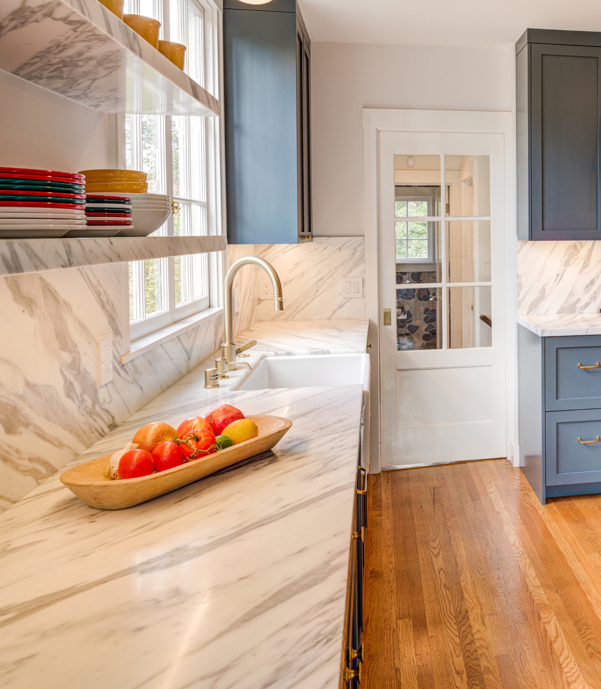 Kitchen with expanded counter space, new shelving, and a new kitchen sink area.