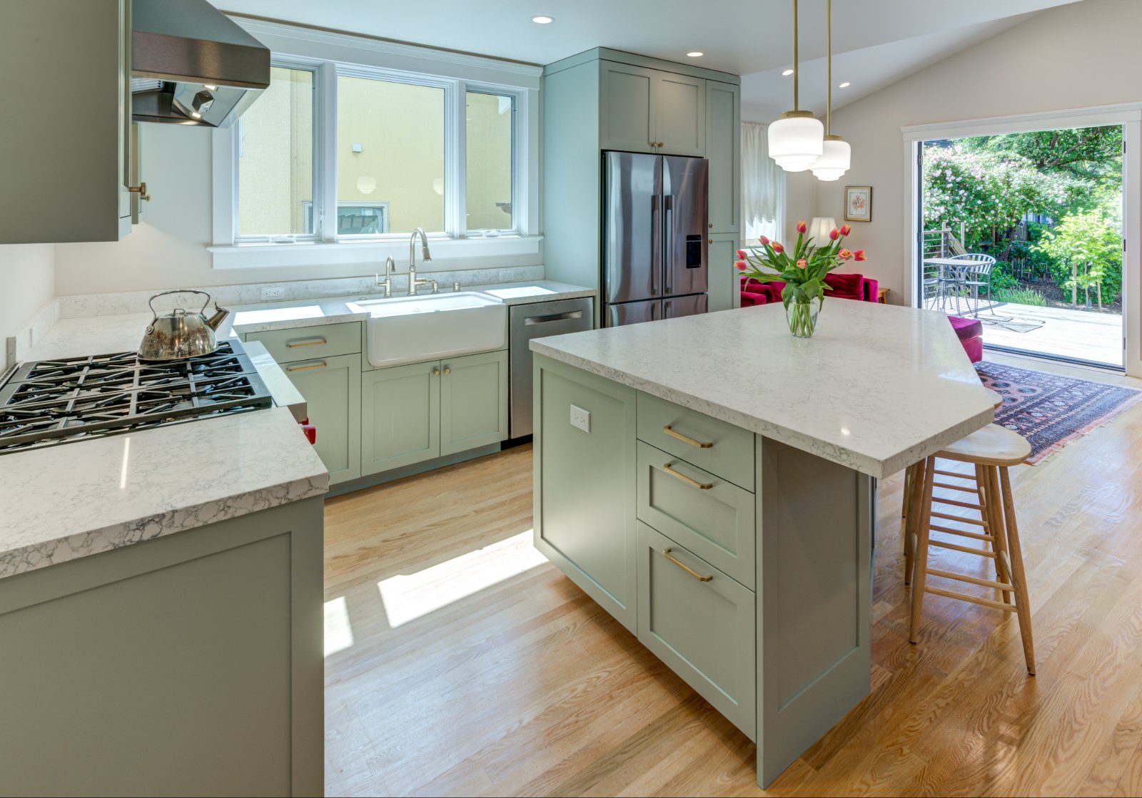 New Kitchen highlighting the island, looking across the Family Room addition and deck toward the backyard