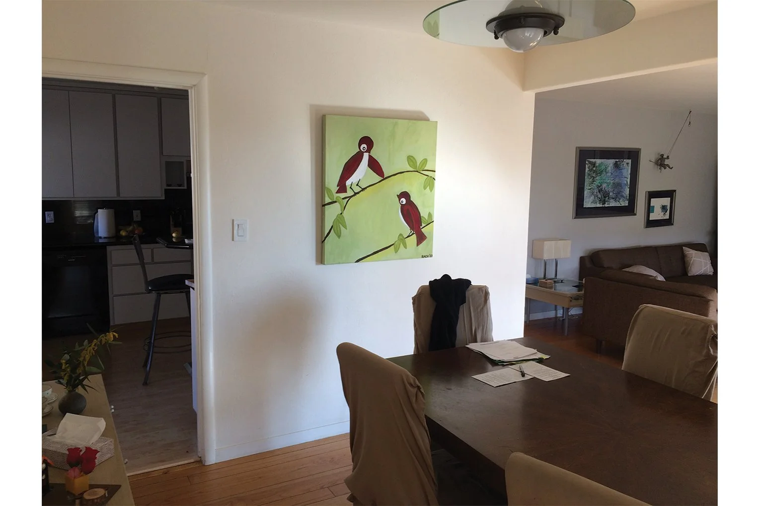 Before photo from the dining area showing the smaller opening to the kitchen and the adjacent living room, prior to Levitch opening the spaces for improved circulation.