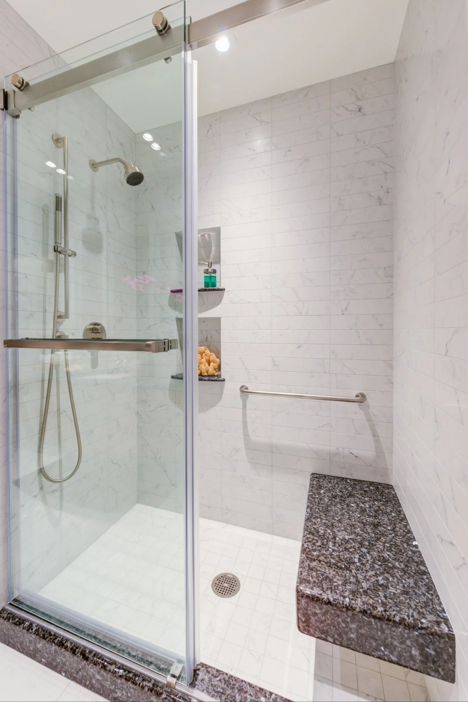 ADU shower with stone bench and matching stone niches