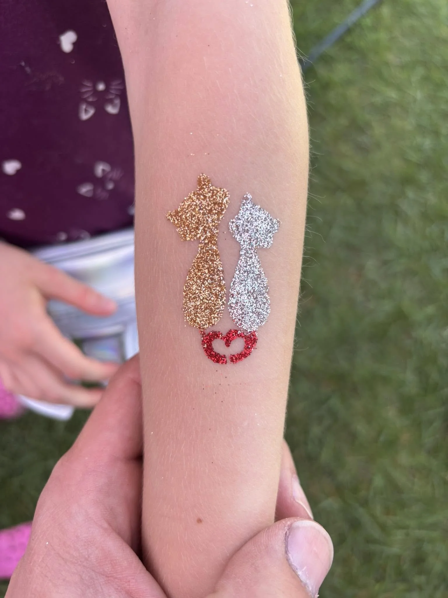 Glitter tattoo of a two cats. Lots of sparkles here. 