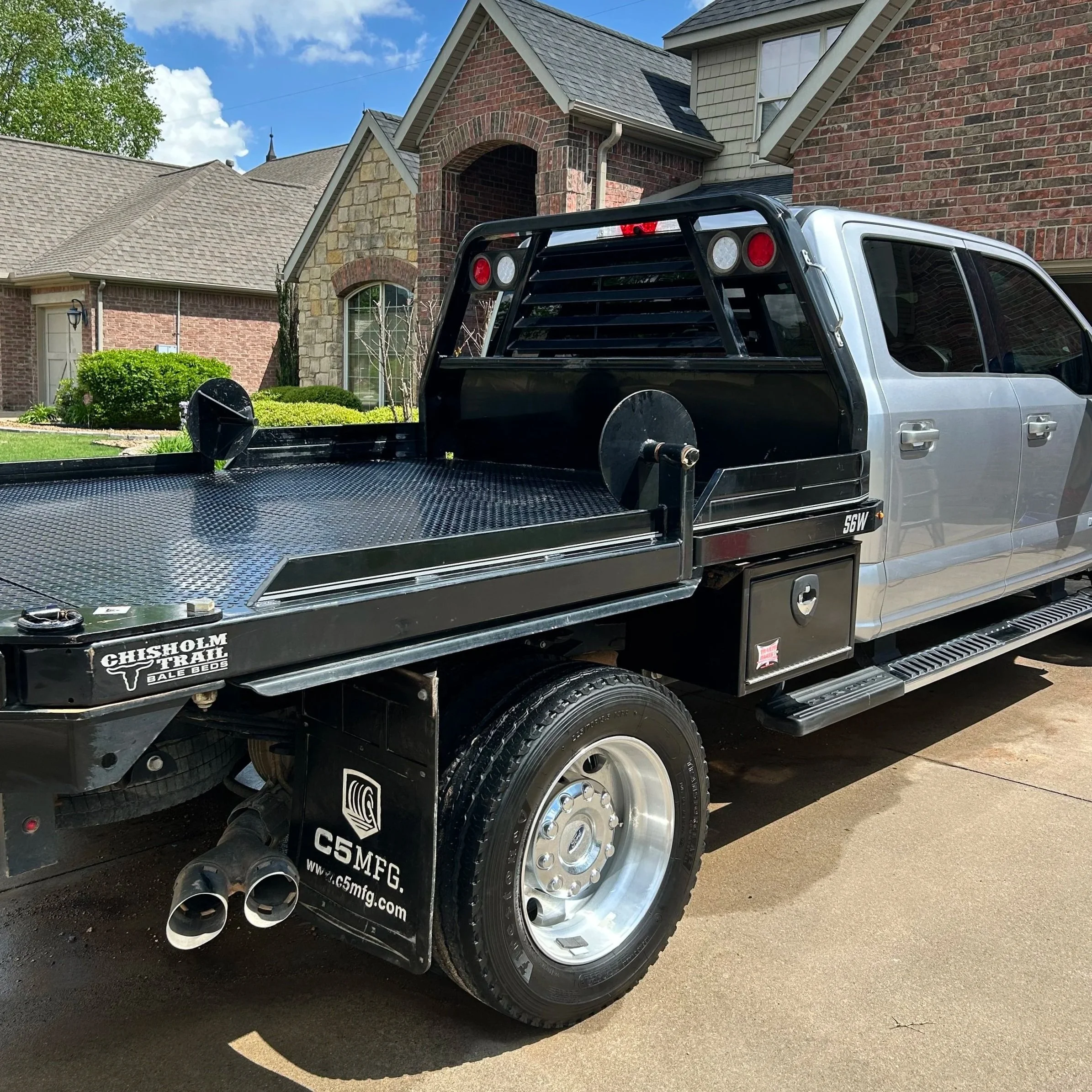 A silver work truck after being thoroughly washed and detailed on the exterior