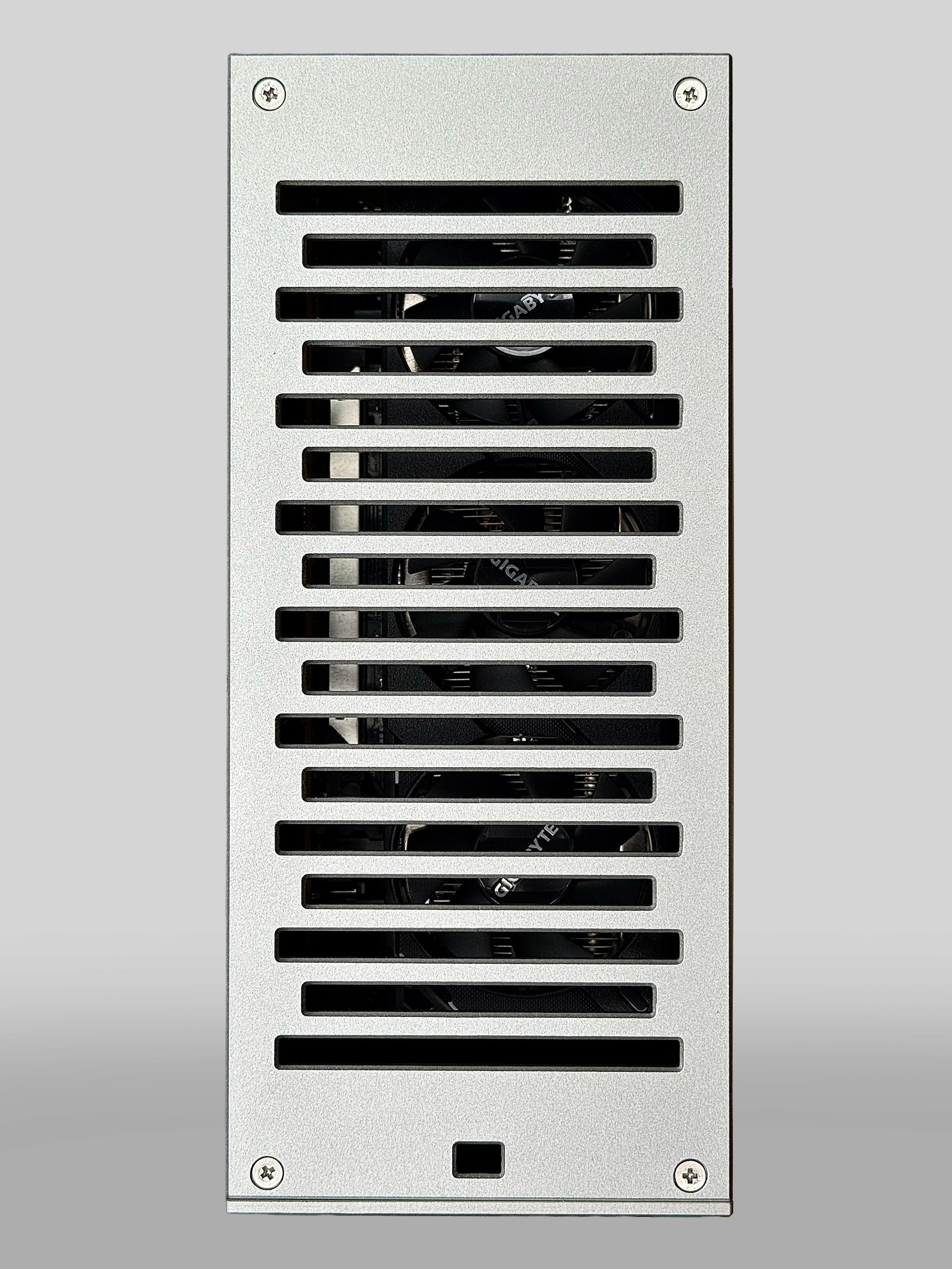 Front view of a computer power supply unit with ventilation grilles showing internal cooling fans.