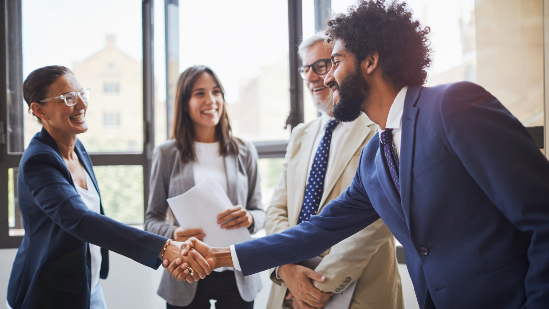 Man shaking hands with business associates