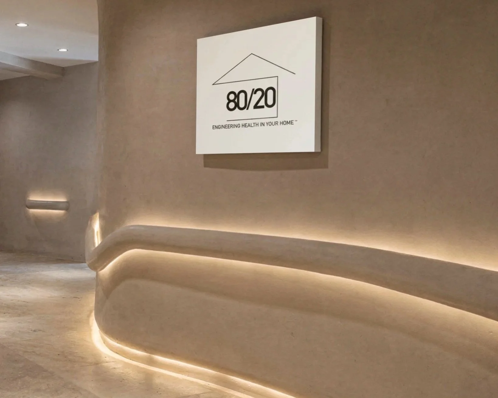 Interior of a building with a curved wall illuminated by LED strip lighting, and a white sign on the wall displaying '80/20' and the text 'Engineering health in your home'.