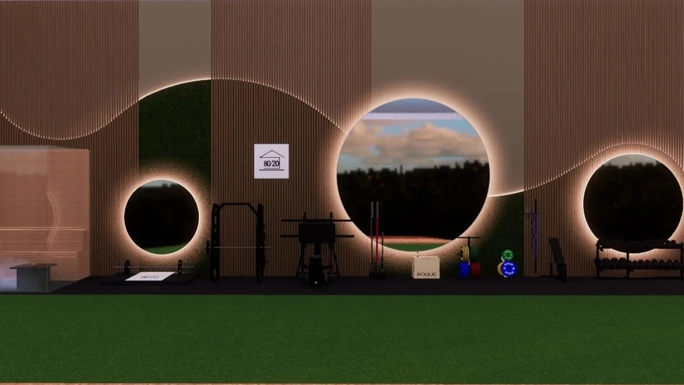 Indoor gym with unique circular window designs, gym equipment, and artificial turf flooring.