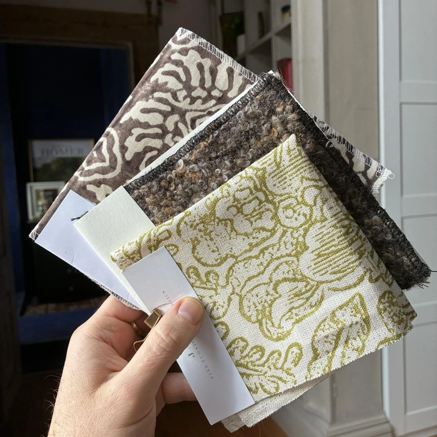 Interior designer holding fabric and textile samples, design process by MODO Design Lab Rhode Island