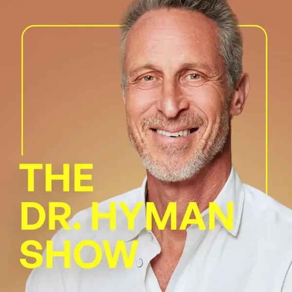 Close-up portrait of a smiling middle-aged man with gray hair and beard, wearing a white shirt, with the text 'The Dr. Hyman Show' in yellow letters.