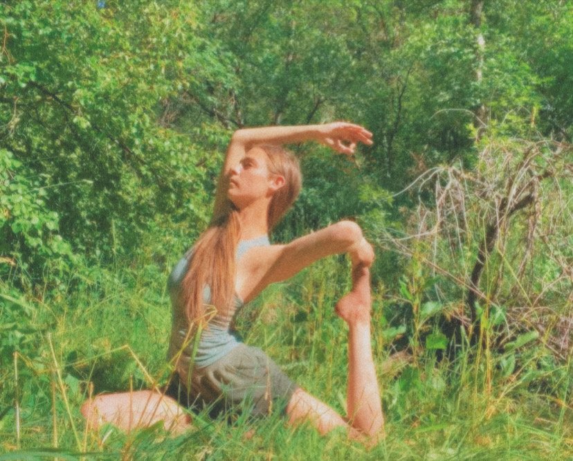 Woman practicing yoga outdoors, representing balance, breathwork, and meditation.