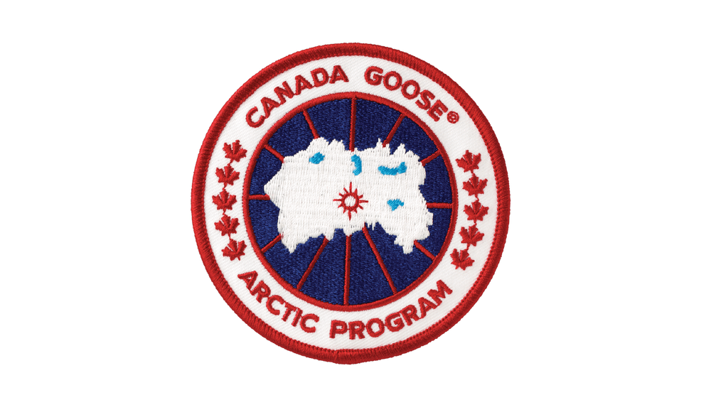 A circular embroidered badge with a map of Canada in the center, surrounded by the words 'Canada Goose Arctic Program' and red maple leaves on a white background with red trim.