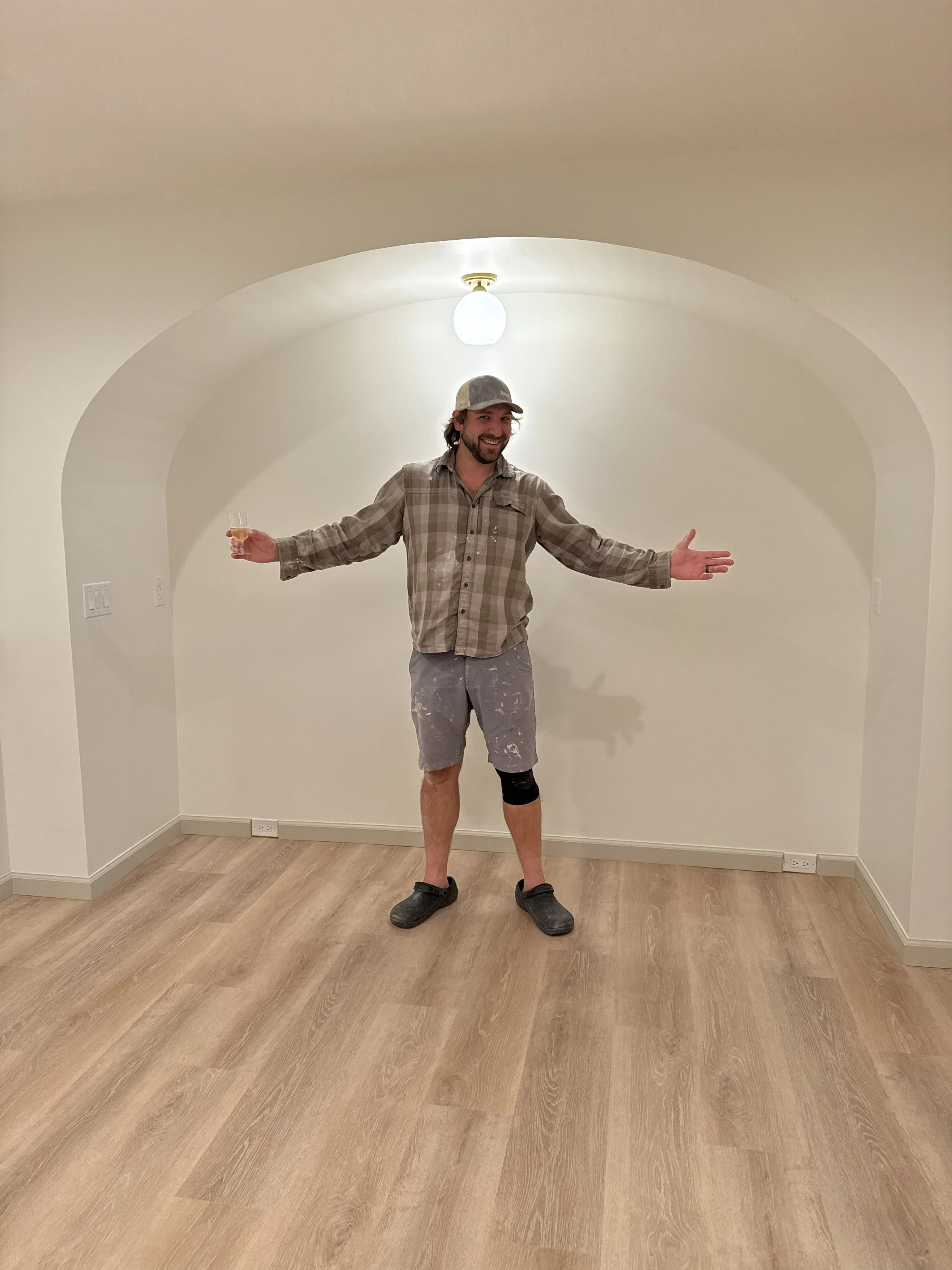 Carpenter standing in arched niche with lighting fixture