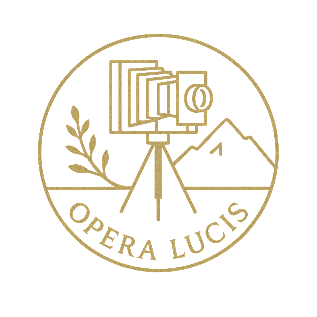 A circular logo featuring a camera on a tripod with a viewfinder, mountains in the background, a plant on the left, and the words "OPERA LUCIS" at the bottom.
