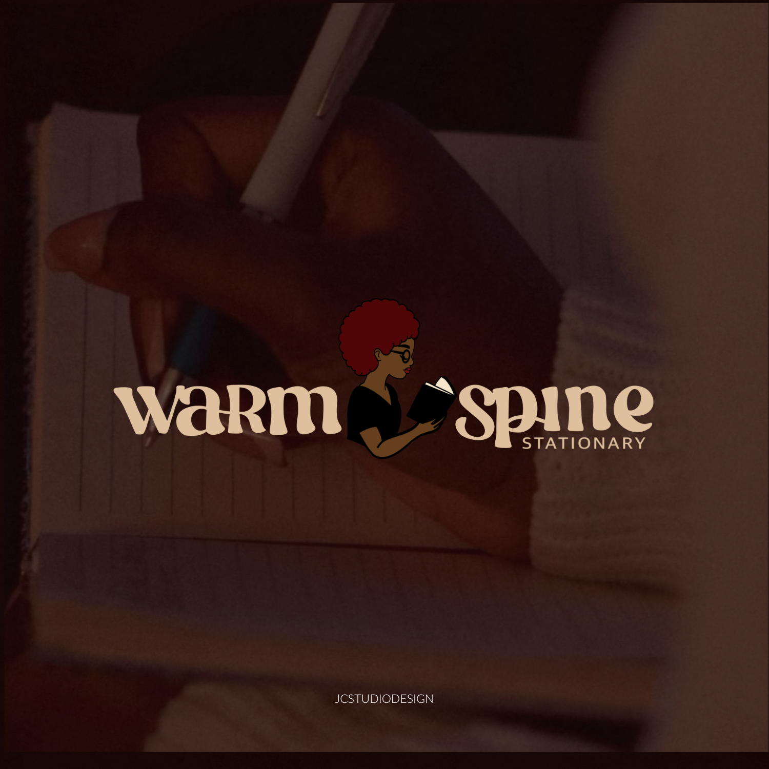 A person's hand holding a pen and writing on a notepad.