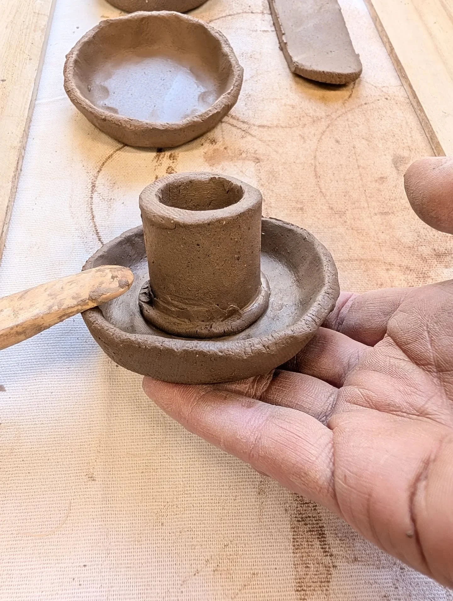 WORK IN PROGRESS shots of the candle stick holders I made today. The hours just disappeared but I managed to make 8 candle holders.

My hands are still finding their way with clay but the more time I set aside to get my hands immersed in it, the more