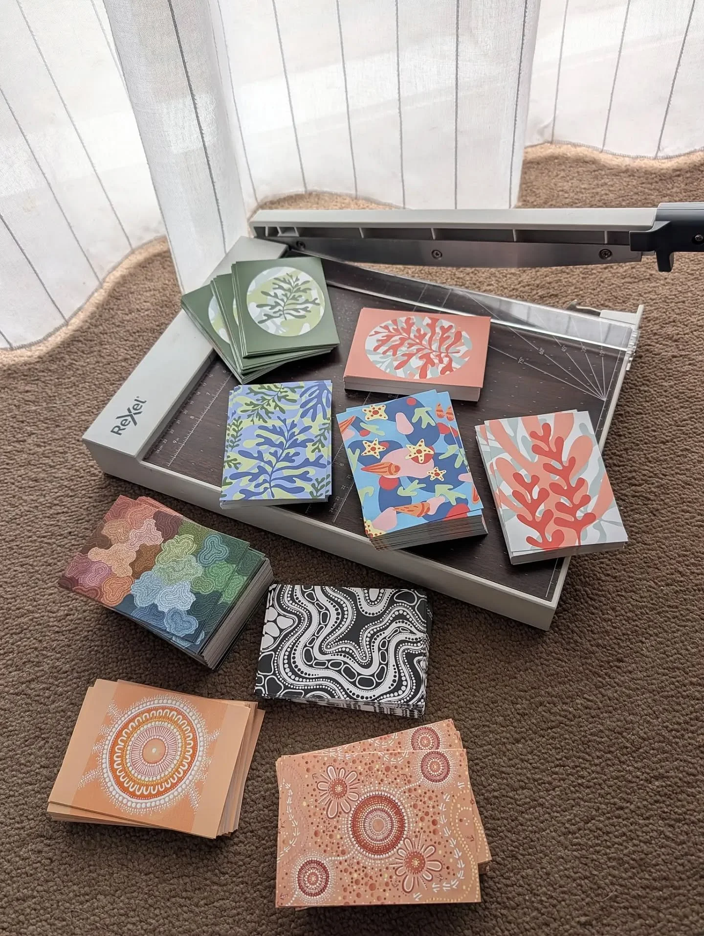 GETTING ORGANISED - a new batch of artwork postcards arrived this week. They are all cut in half and stacked on shelves in my studio, for quick access to add to orders.

These cards are the perfect way to show the full artwork that the jewellery desi