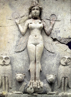 Ancient stone carving of a woman with wings holding a staff, flanked by four skull carvings.