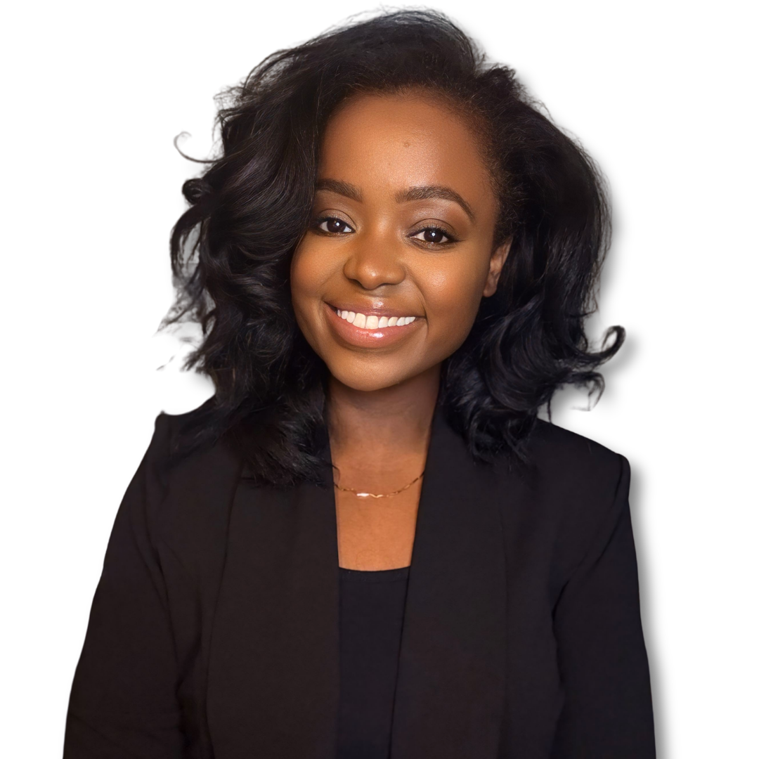 Portrait of a smiling African American woman with curly black hair, wearing a black blazer and a gold necklace.