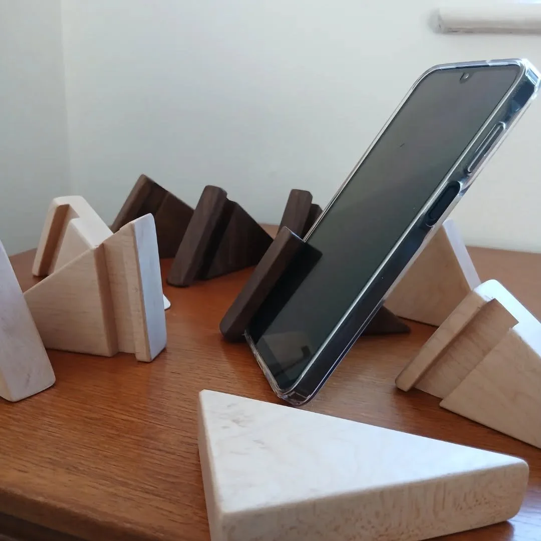 Various handcrafted phone holders available at

https://www.brookwillowstudio.com/