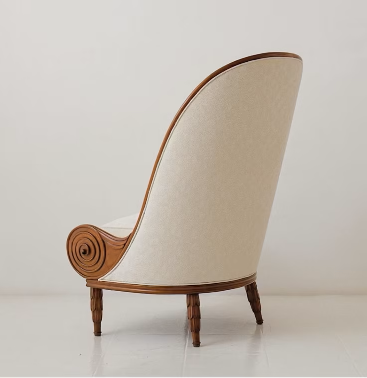 A beige vintage-style armchair with wooden accents and spiral scroll details on the side, positioned against a plain white wall.