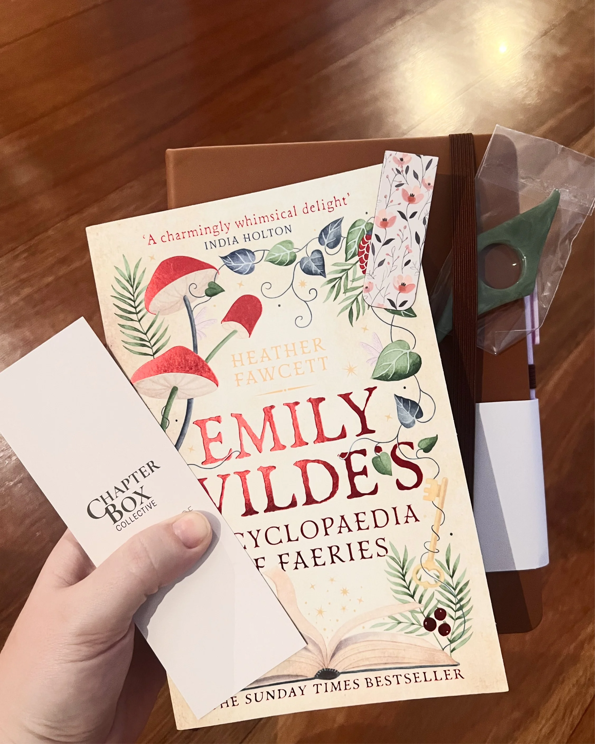 Hand holding book, bookmark notebook and thumb holder