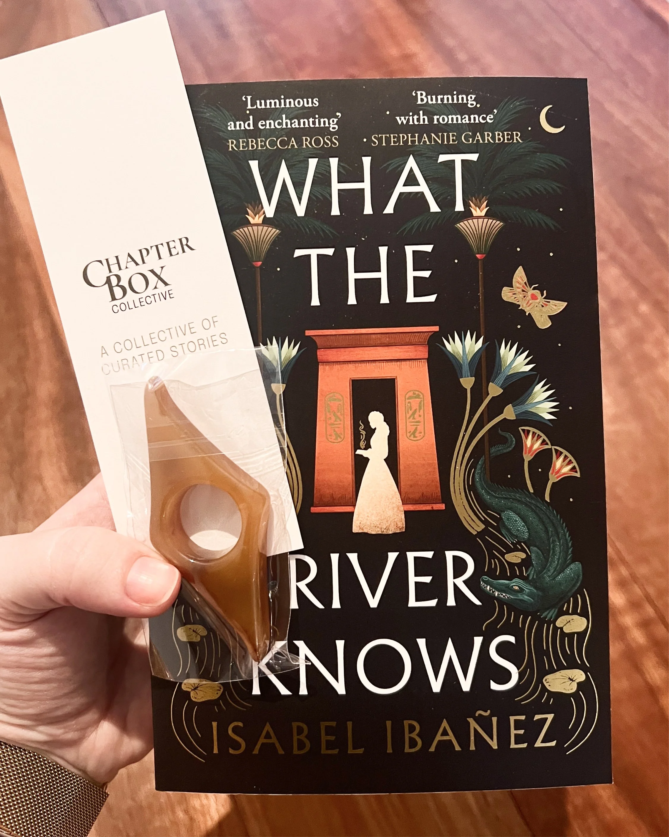 Hand holding book, bookmark and thumb holder