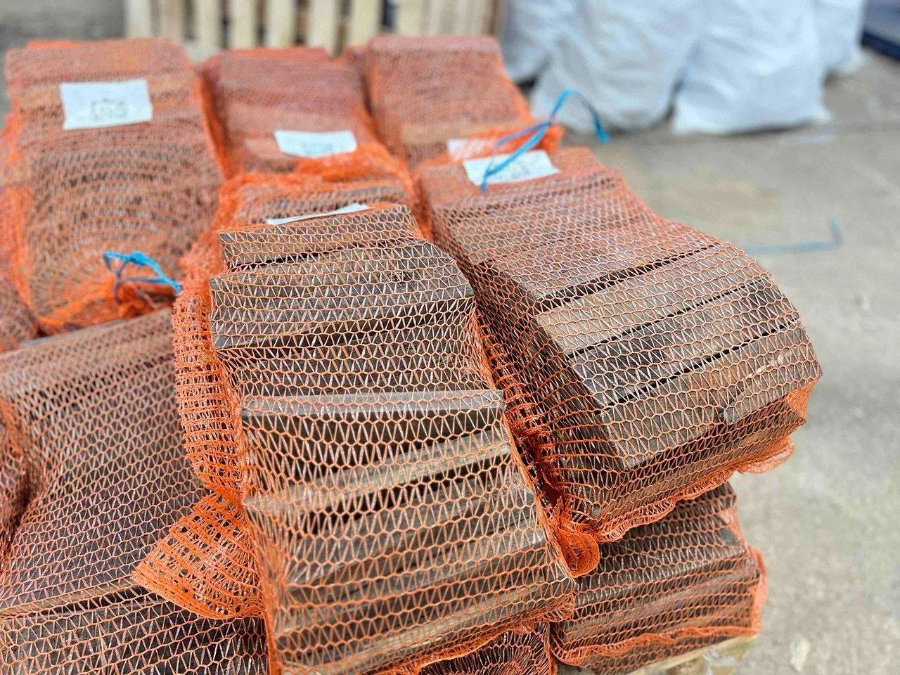 Stacked whisky staves ready to be used as firewood, arranged horizontally.